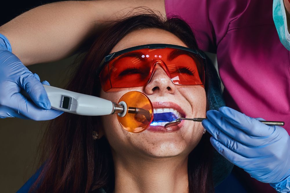 a woman is getting dental treatment