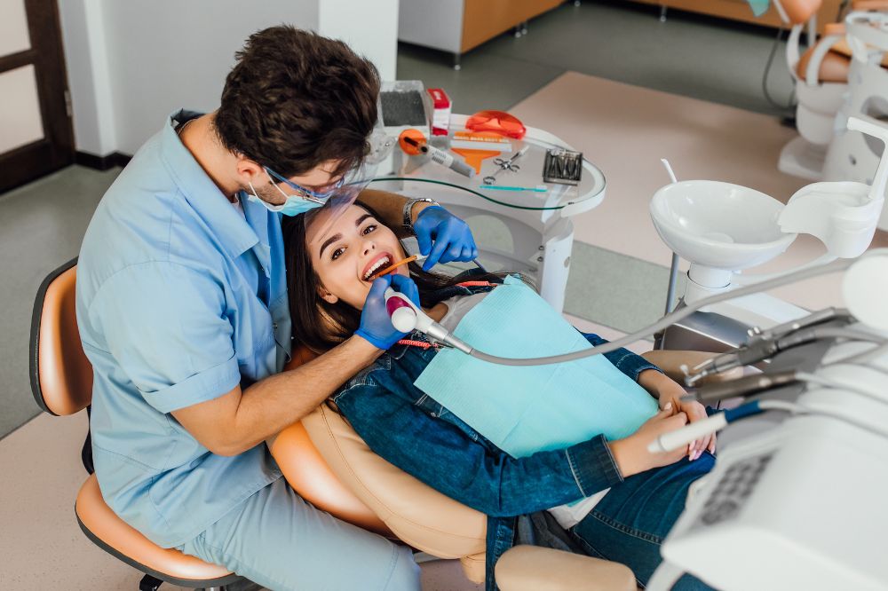 a woman is getting dental treatment