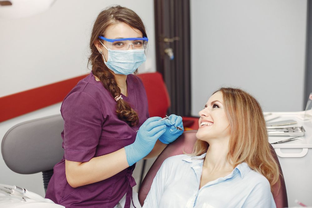 a woman is getting dental treatment